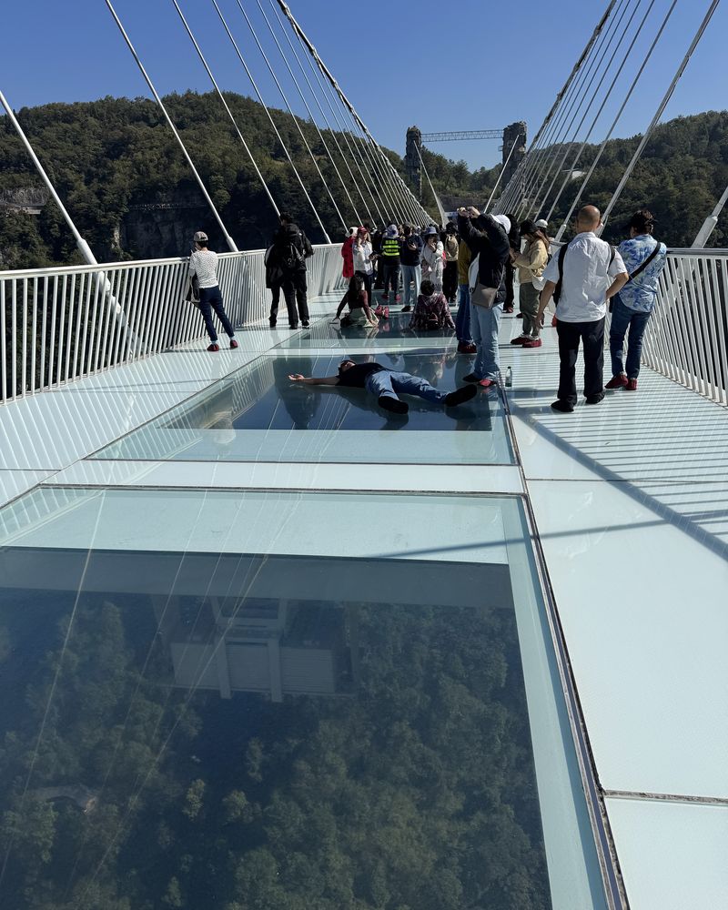 Visitors crossing the Zhangjiajie Glass Bridge